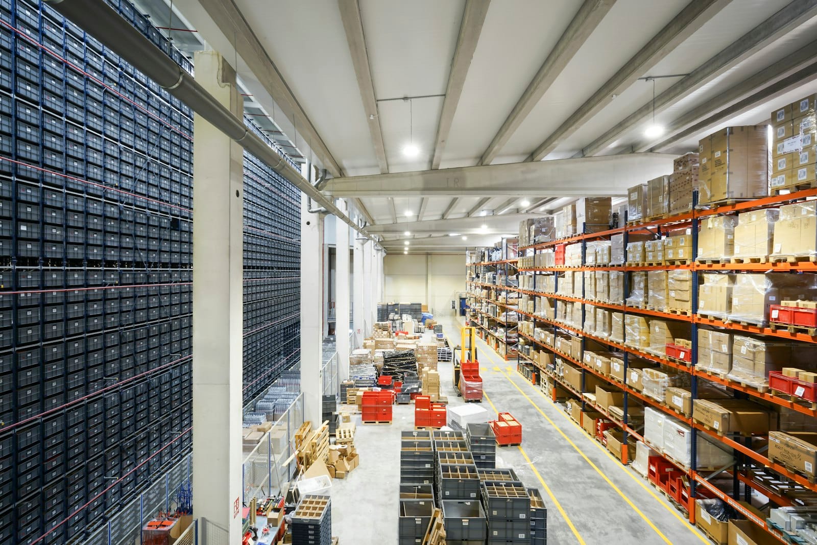 The interior of a large modern fulfilment warehouse with high racking and boxes